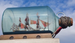 This is actually a HUGE ship in a bottle. It sits on top of a cement cinder